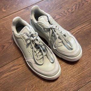 All green Adidas sneakers. Size 8.5. Worn but in very good condition.